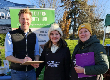 John signing residents' petition 